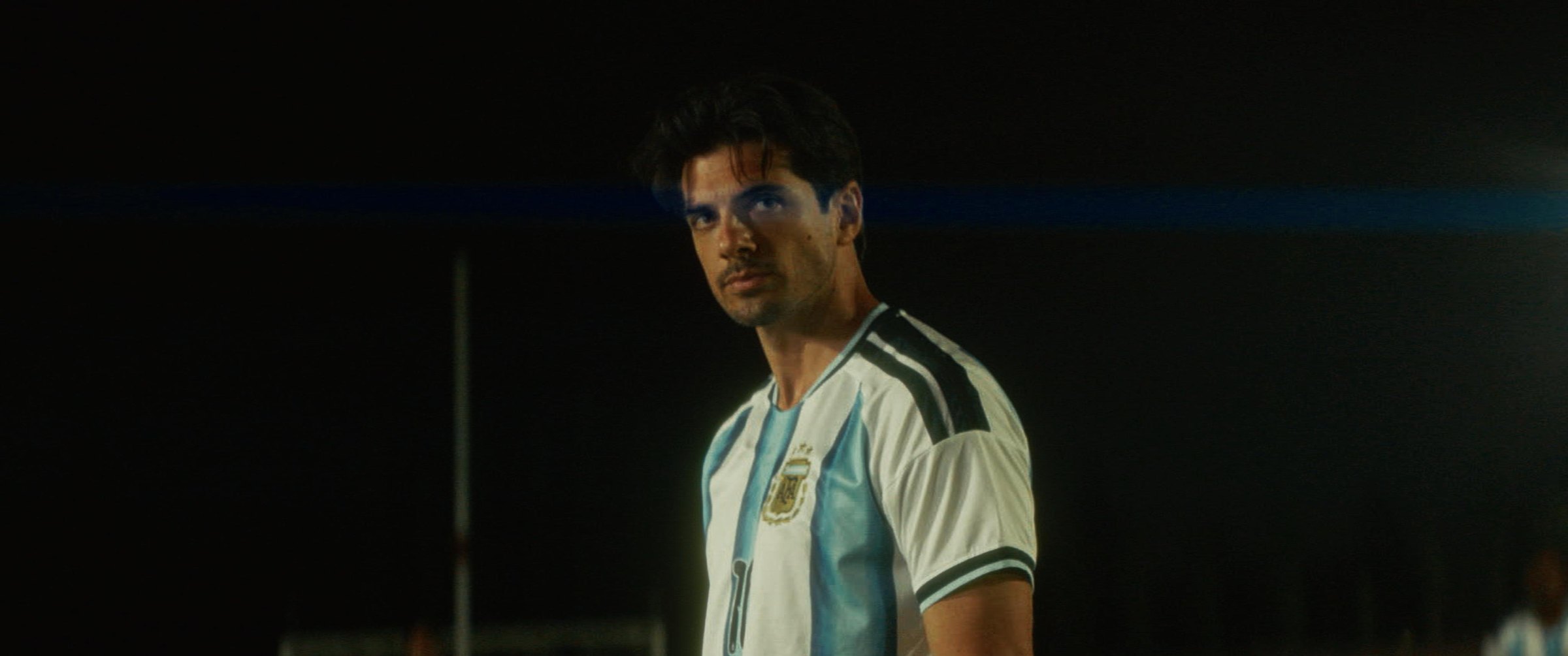 Still from the Argentina football commercial: a player in an Argentina jersey under night lights