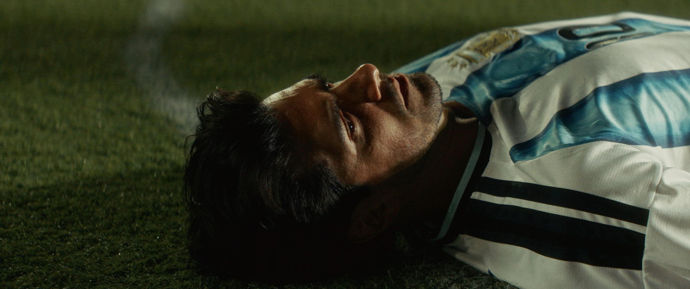 Still from the Argentina football commercial: a player in an Argentina jersey lying on the pitch