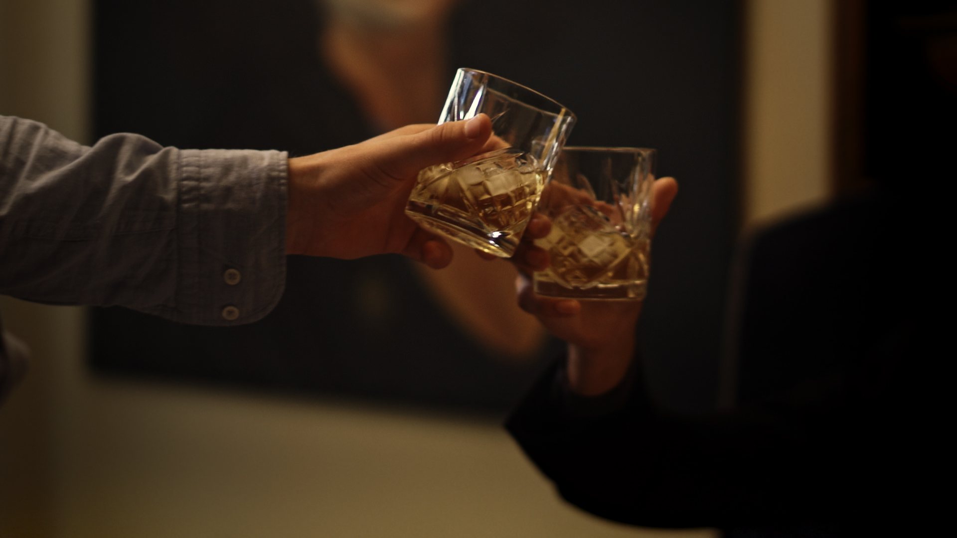Still from God's Second Best Man: two whiskey glasses meeting in a toast