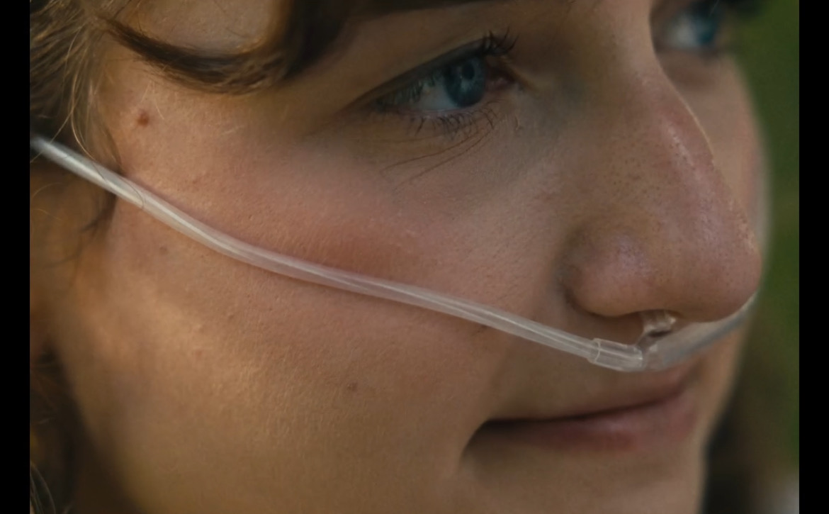 Still from What's Life: a close portrait of a girl with a nasal cannula